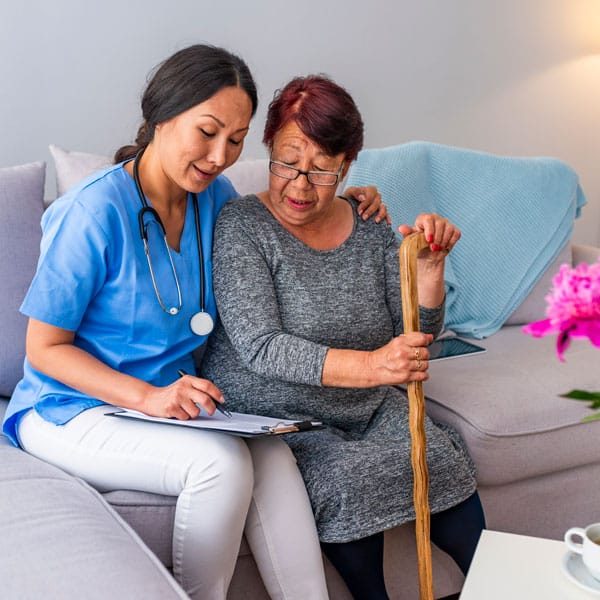 female caregiver going over paperwork with client