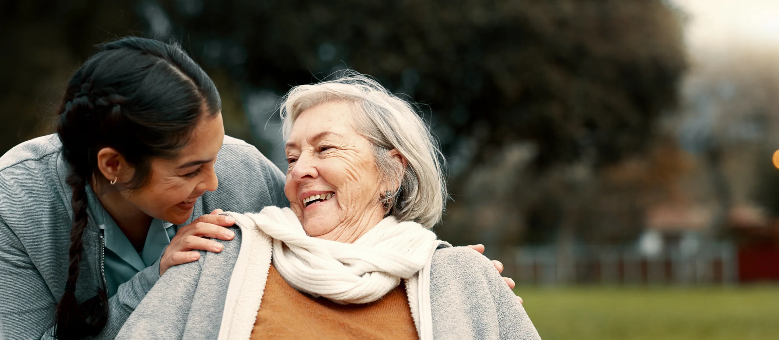 A caregiver sitting with a client during a memory-care visit