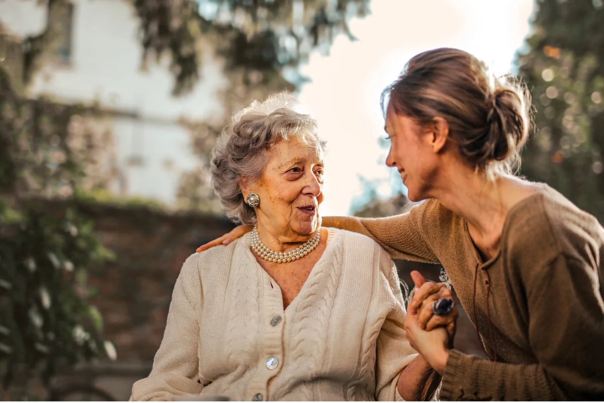 A caregiver walking arm in arm with a senior client